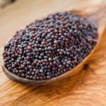 black-mustard-seeds----indian-spices-on-wooden-spoon--macro--911766480-71fd9cf103db41158be06d244f16b496